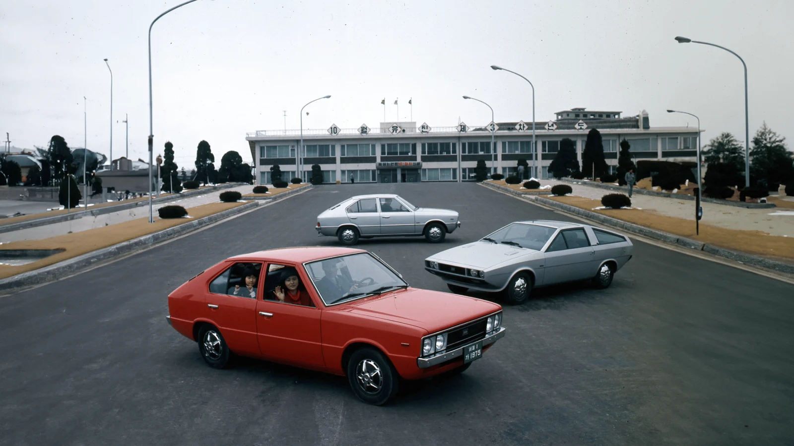 Pony models and the silver Coupe outside Hyundai's factory